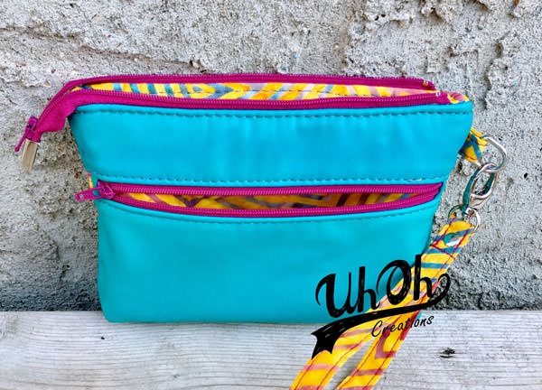 Look at that pop of pink on the zippers of this Gather Me Up Clutch - Andrie Designs